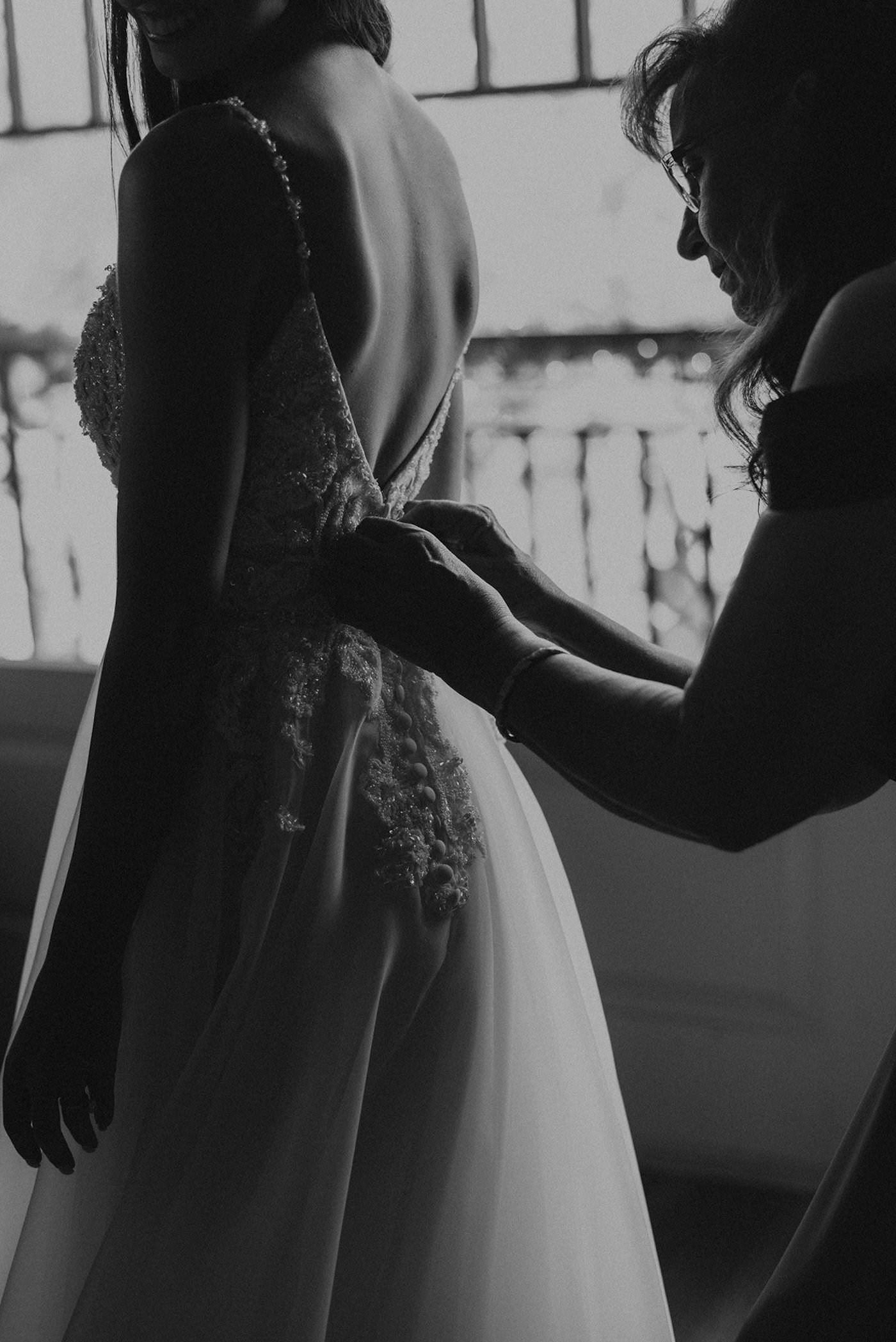 Mom Helping Bride Get Dressed and Ready | Black and White Wedding Photography Shot