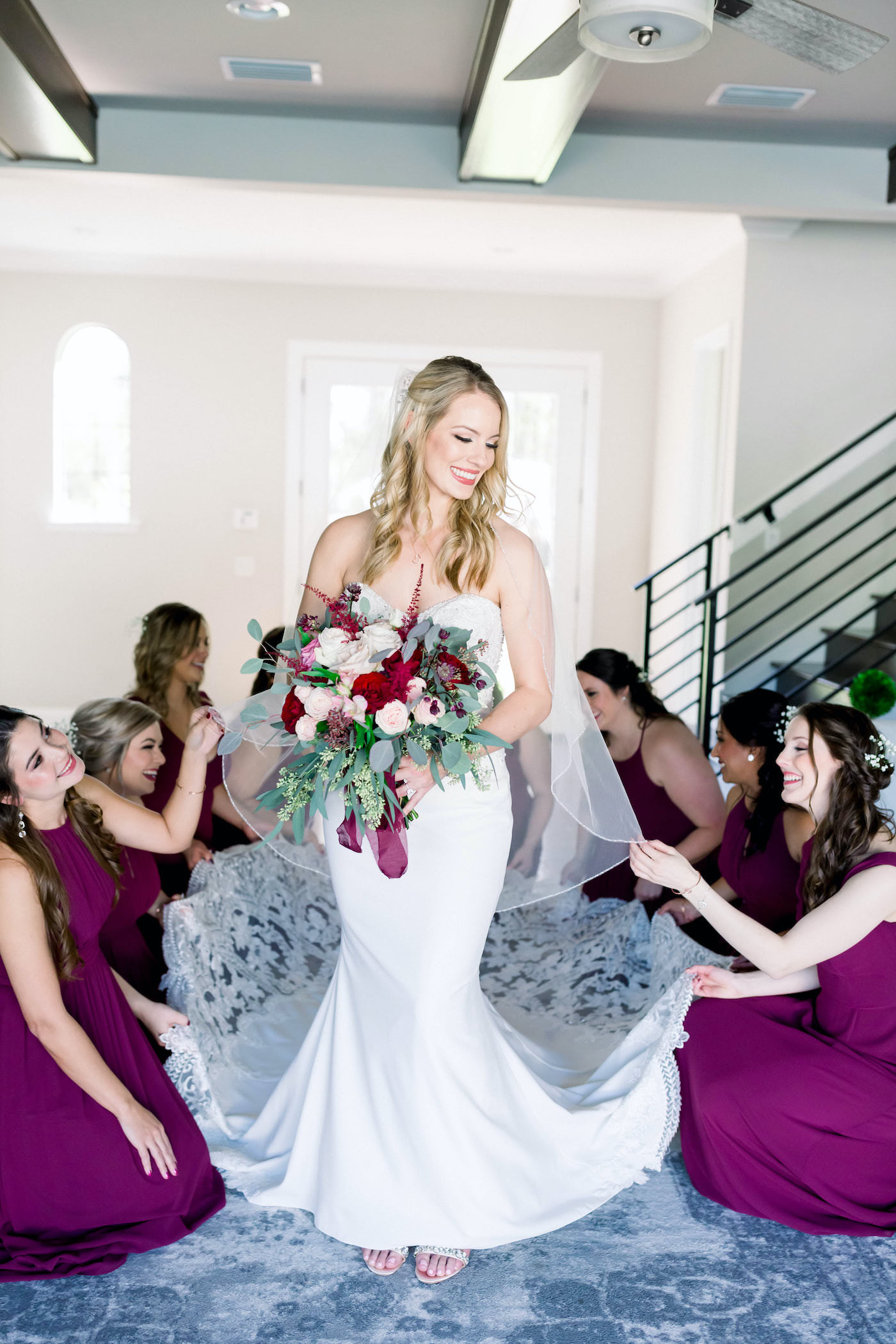 Bridesmaids Helping Bride Get Ready Shot | Burgundy and Blush Pink Bridal Bouquet with Roses and Astilbe and Eucalyptus Greenery | Shauna and Jordon Photography
