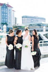 Classic Bride with Bridesmaids in Matching Black Dresses Holding White Floral Bouquets | Wedding Photographer Shauna and Jordon Photography | Tampa Wedding Planner UNIQUE Weddings + Events | Wedding Hair and Makeup Femme Akoi Beauty Studio