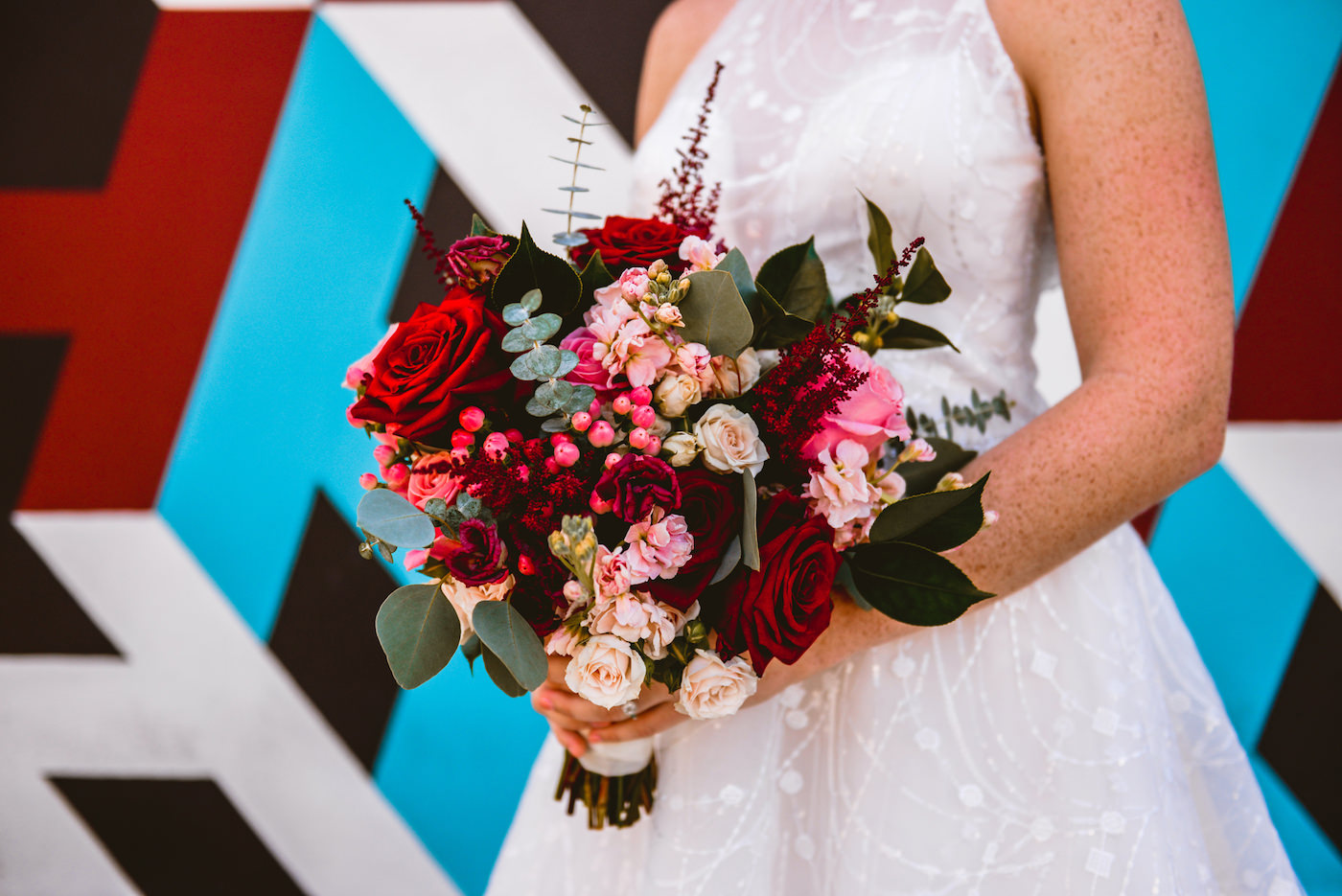 Bridal Bouquet with Deep Red Maroon Roses and Blush Pink Hypericum Berries with Freesia and Astilbe and Eucalyptus Greenery