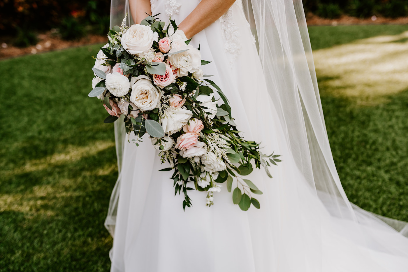 Cascade Bridal Bouquet with White and Blush Pink Roses and Ranunculus, White Astilbe, Ivory Stock, Greenery and Eucalyptus | Tampa Wedding Florist Monarch Events and Design