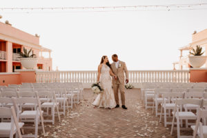 Bride and Groom Portrait at Clearwater Wedding Venue Hyatt Regency Clearwater Beach Hotel | Outdoor Rooftop Waterfront Wedding with White Garden Chairs | Champagne Lace Sheath Illusion Neck Bridal Gown | Groom Khaki Tan Suit