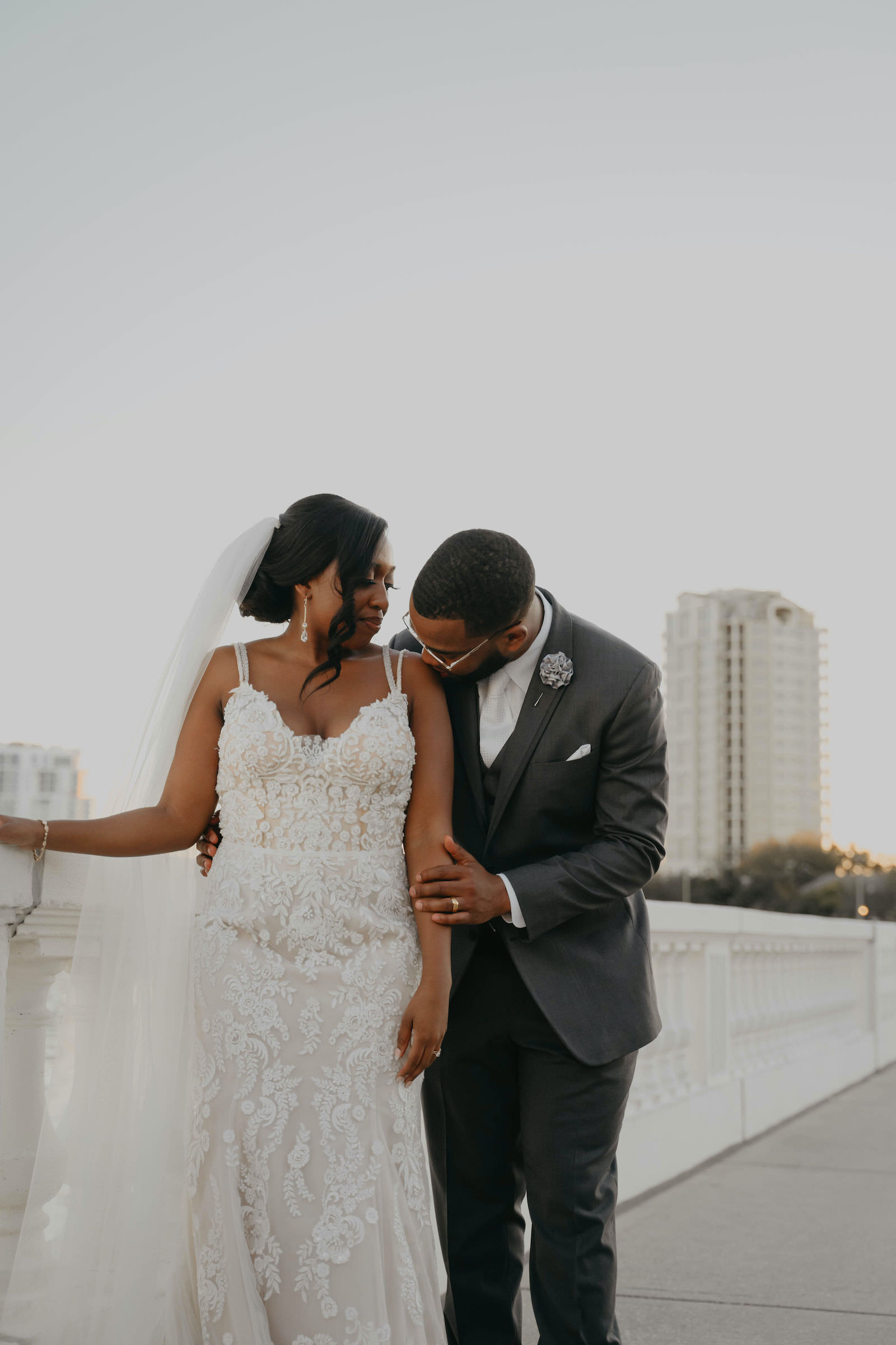 Bride and Groom Outdoor Portrait on Bayshore | Groom in Classic Charcoal Grey Suit | Mori Lee Ivory Lace over Champagne Lining Spaghetti Strap V Neck Mermaid Bridal Gown with Long Cathedral Veil