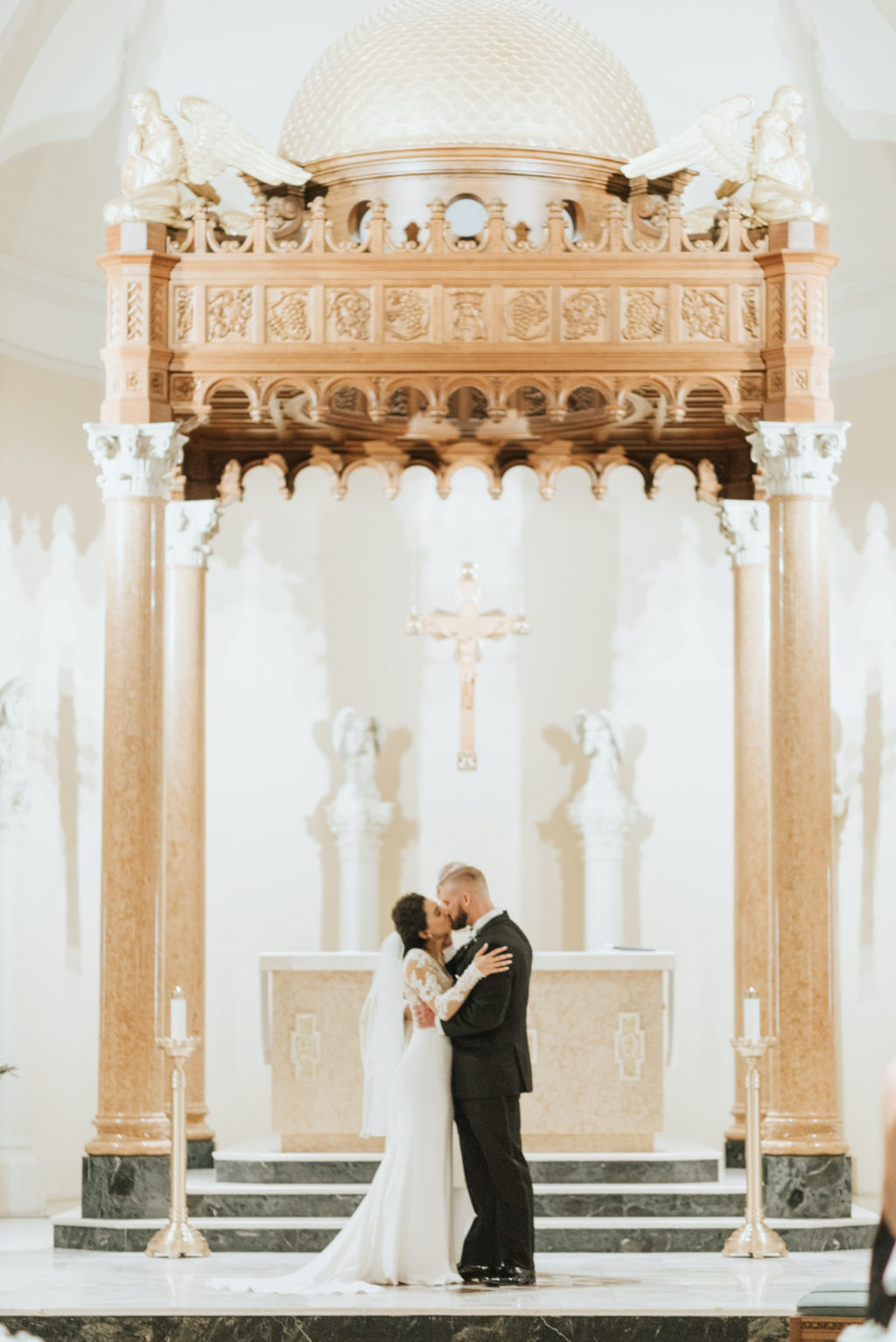 Classic Florida Bride and Groom Kiss At the Altar of Saint Mary Our Lady of Grace Catholic Church| Tampa Bay Wedding Planner Blue Skies Weddings and Events