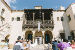 Florida Bride and Groom Exchange Vows in Courtyard Wedding Ceremony at Historic Powel Crosley Estate | Tampa Bay Destination Wedding Planner Special Moments Event Planning | Gold Chiavari Chair Rentals Gabro Event Services | Florida Wedding Photographer Kera Photography