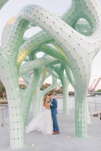 Sunset Tampa Bride and Groom Under Whimsical Green Artsy Sculpture