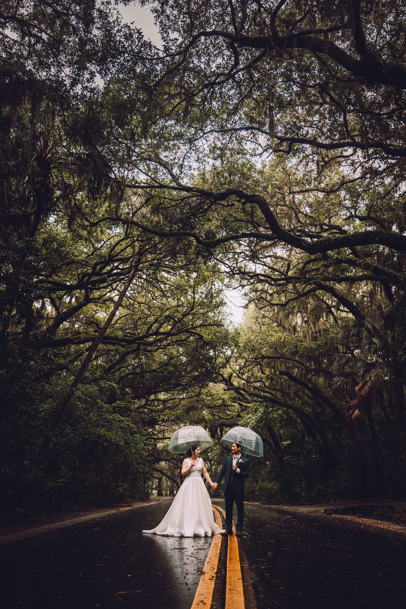 Bride and Groom Rainy Wedding Day Portrait with Clear Umbrellas | St. Petersburg Florida Wedding
