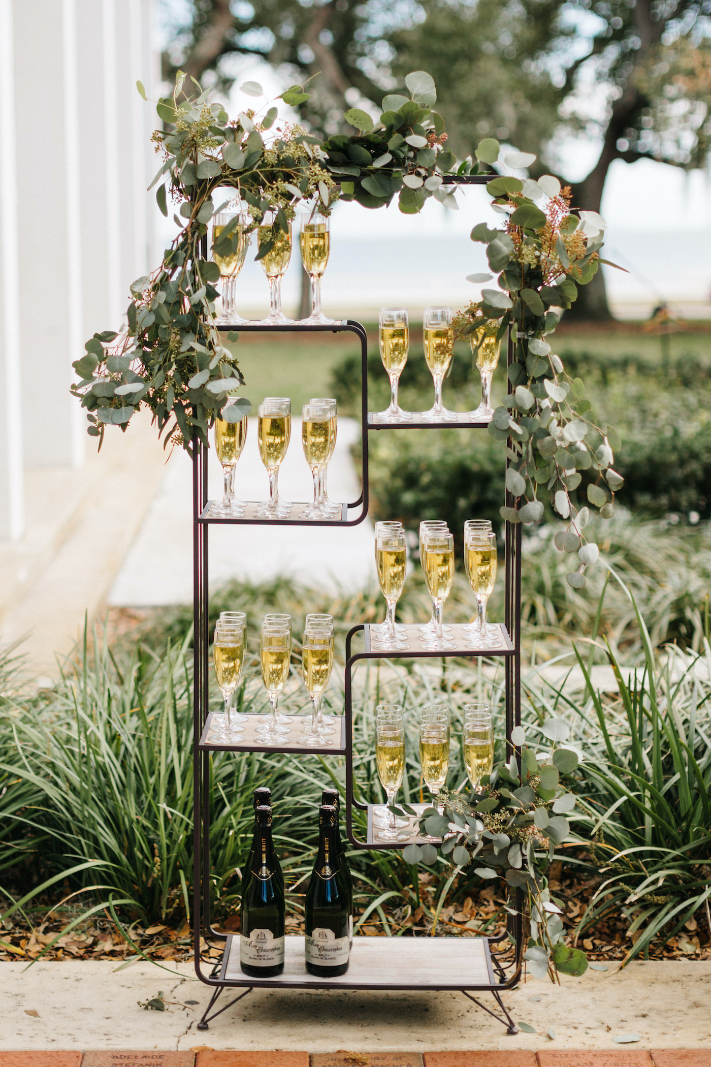 Outdoor Tampa Garden Wedding Welcome Drink Champagne Shelf Display with Eucalyptus Greenery Garland | Winsor Event Studio