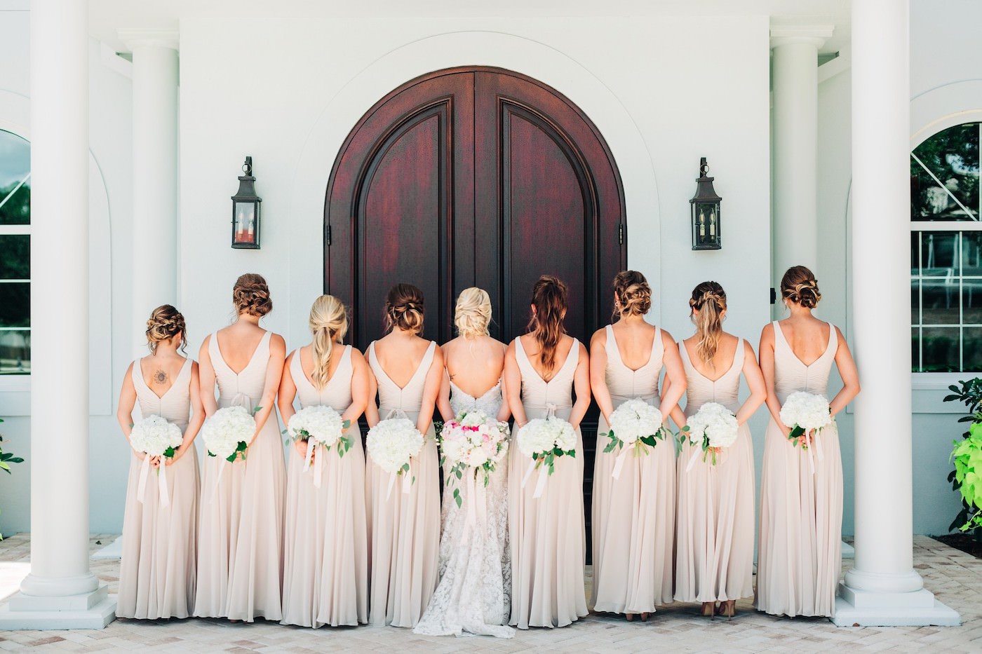 Outdoor Wedding Bridal Party Portrait | Neutral Nude Champagne Watters Bridesmaid Dresses from Bella Bridesmaid | White Hydrangea Bouquets with Cascading Ribbon | Champagne and Ivory Lace Sheath Spaghetti Strap Wedding Dress Bridal Gown with Low Back