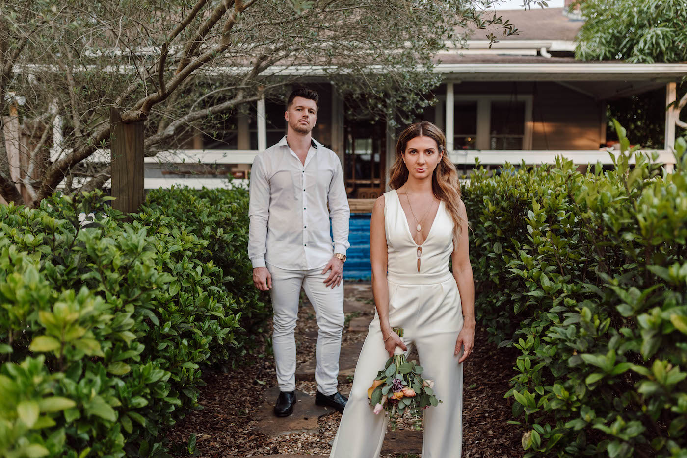 Bride and Groom Outdoor Wedding Portrait | COVID Wedding Elopement Backyard Ceremony | Ivory White Bridal Jumpsuit | Casual Groom White Shirt and Pants