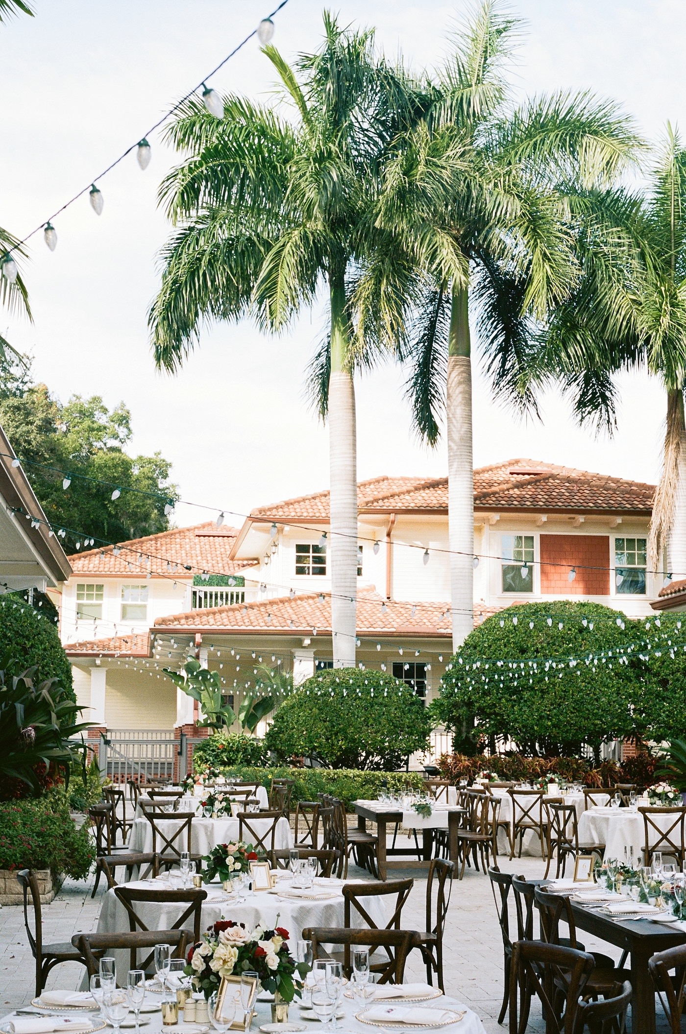 Florida Outdoor Wedding Reception with Canopy String Lights and Wood Cross Back French Country Chairs