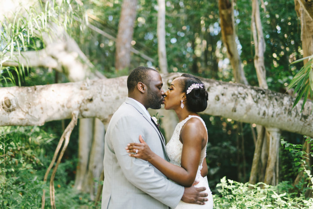 Florida Bride and Groom Intimate Exchange Wedding Portrait in Front of Tropical Backdrop | Florida Wedding Photographer Kera Photography