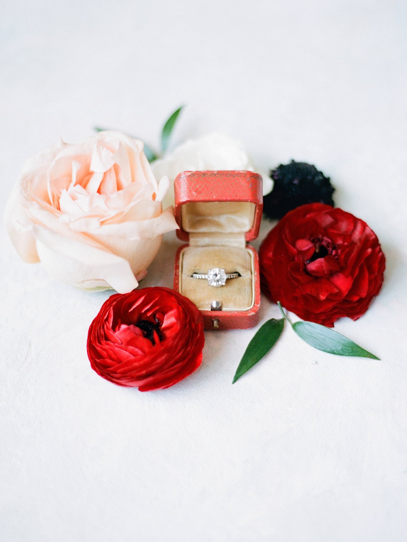Fall Autumn Wedding Ring Box Shot with Red Ranunculus and Cream Rose | Red Cartier Engagement Ring Box with Round Solitaire Diamond and Channel Set Band | Brides N Blooms