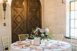 Romantic Wedding Decor at Reception, Low Floral Centerpiece with Gold Vase, Dark Red Burgundy Roses, Light Pink King Protea, Ivory Flowers, on White Linen Round Table with Gold Chiavari Chairs and Blush Cloth Linens and Gold Napkin Rings and Table Number | Historic Powel Crosley Estate | Tampa Bay Wedding Photographer Kera Photography | Florida Wedding Planner Special Moments Event Planning | Tampa Bay Wedding Rental Gabro Event Services