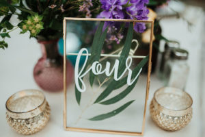 Minimal Wedding Reception Decor, Gold Frame with White Script Table Number, Small Gold Candle Holders, Purple Wildflowers Centerpiece