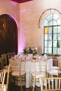 Romantic Wedding Decor at Reception, Low Floral Centerpiece with Gold Vase, Dark Red Burgundy Roses, Light Pink King Protea, Ivory Flowers, on White Linen Round Table with Gold Chiavari Chairs and Blush Cloth Linens and Gold Napkin Rings and Table Number | Historic Powel Crosley Estate | Tampa Bay Wedding Photographer Kera Photography | Florida Wedding Planner Special Moments Event Planning | Tampa Bay Wedding Rental Gabro Event Services