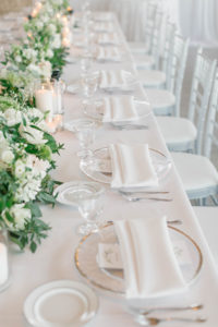 Elegant Boho Chic Wedding Reception Decor, Long Feasting Table with White Linens, Gold Rimmer Chargers, Greenery and White Floral Garland | Tampa Bay Wedding Florist Bruce Wayne Florals | Charger Rentals Gabro Event Services | Wedding Planner Parties A'la Carte