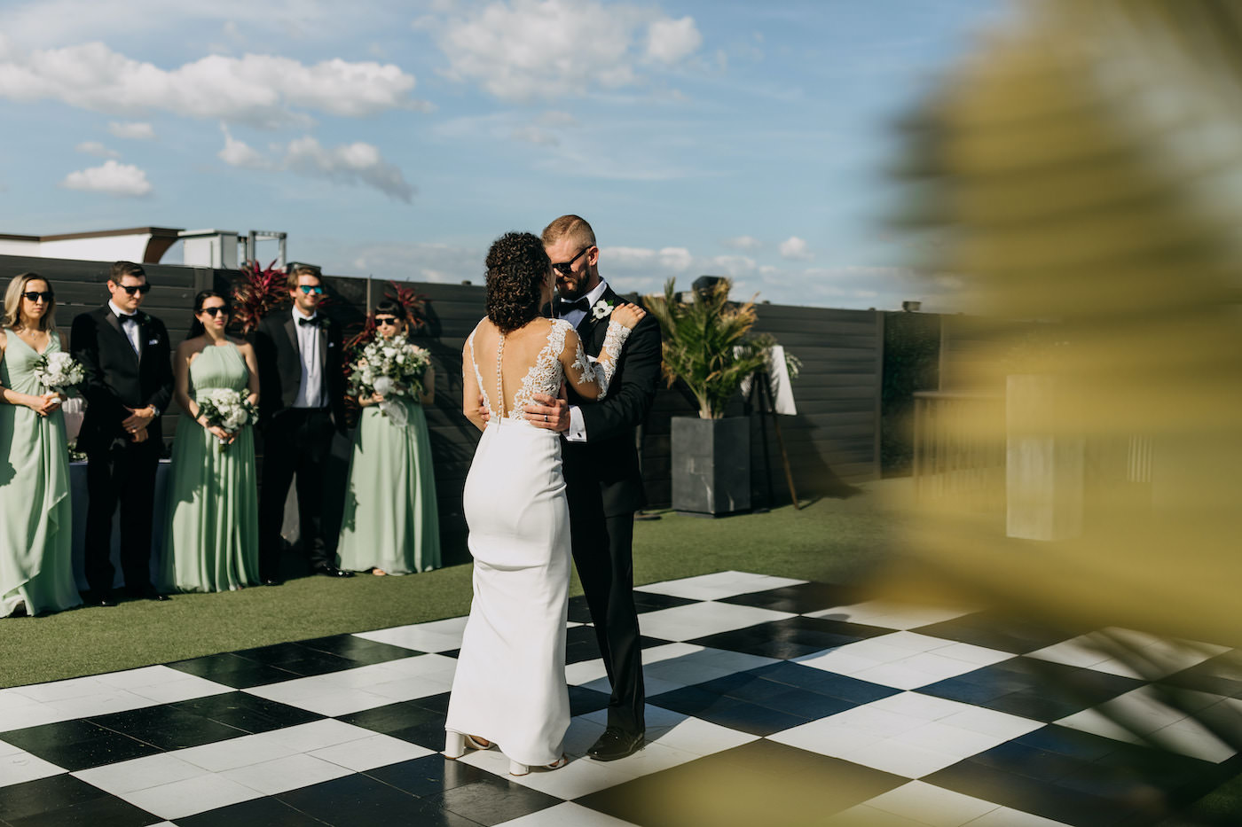 Florida Bride and Groom First Dance on Checkered Black and White Dancefloor on Rooftop Bar of The Hotel Zamora on St. Pete Beach | Tampa Bay Wedding DJ Grant Hemond and Associates | Rentals Gabro Event Services