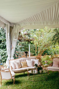 Romantic, Garden Inspired Wedding Reception Decor In Tented Outdoor Florida Wedding, Luxurious Lounge Chairs with Blush Pink Velvet, Elegant Arm Chairs, Gold Sequined Pillow Accents, Modern and Vintage Furniture | Sarasota Wedding Planner NK Weddings