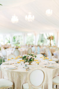 Romantic, Garden Inspired Wedding Reception Decor In White Tented Outdoor Florida Wedding, Round Tables with Gold Linens,Modern Circle Back Chairs, Gold Accented Table Setting, Chandelier, Low Floral centerpiece with Blush Pink Flowers and Greenery | Sarasota Wedding Planner NK Weddings
