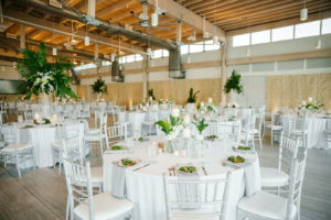 Tropical Tampa Florida Wedding Reception | White Wedding Reception Tables with Silver Chiavari Chairs and Tall Tropical Palm Leaf Centerpiece with White Orchids | Tampa Wedding Florist Bruce Wayne Florals