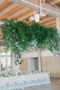 Elegant Boho Chic Wedding Reception Decor, Long Feasting Table, Silver Chiavari Chairs, White Linens, Greenery Hanging Chandelier from Ceiling | Tampa Bay Wedding Planner Parties A'la Carte | Wedding Florist Bruce Wayne Florals | Wedding Venue Tampa River Center