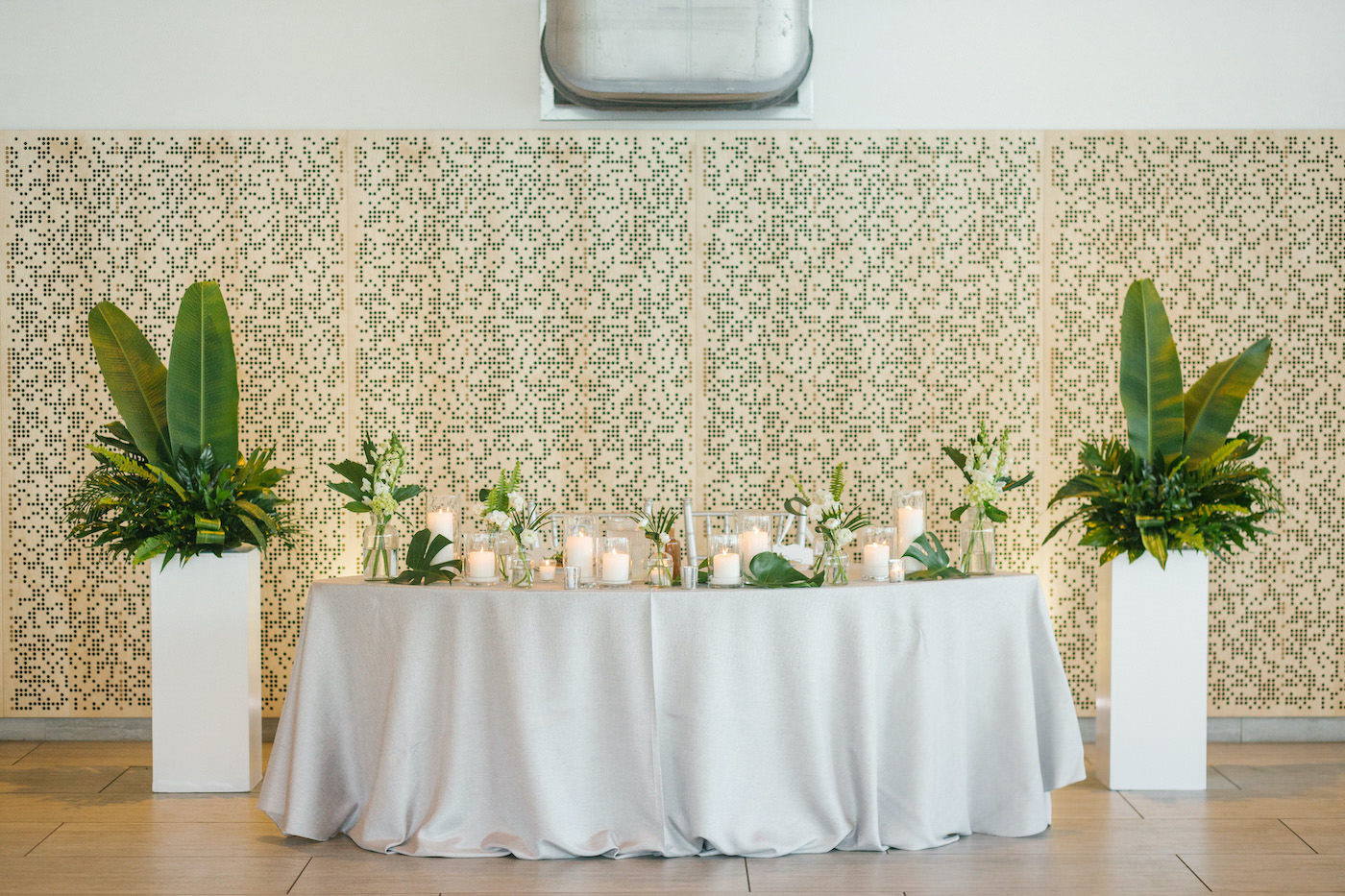Tropical Tampa Florida Wedding Reception | Wedding Sweetheart Table with Tropical Palm Leaf Centerpiece with White Orchids and Candles and Bud Vases | Tampa Wedding Florist Bruce Wayne Florals