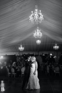 Sarasota Bride and Groom First Dance under Crystal Chandeliers of Tented Outdoor Reception, Black and White | Florida Wedding Planner NK Weddings