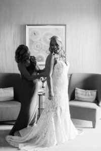 Florida Bride and Mother Getting Ready Photo, Mom Putting On Daughters Dress, Bride Wearing Hayley Paige White and Ivory Wedding Dress with Lace Overlay Detailing