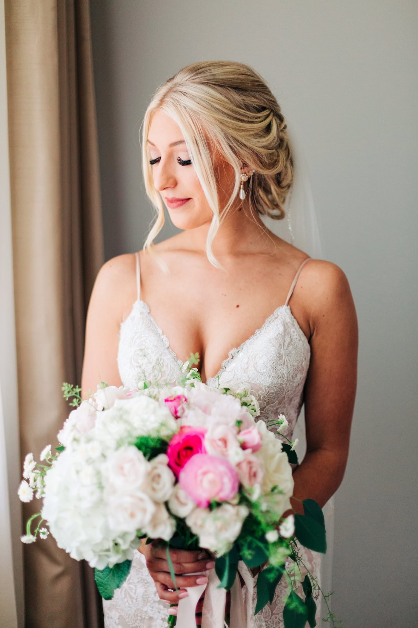 Soft Curls Chignon Updo Bride Wedding Hairstyle | Bridal Bouquet with White Hydrangea and Pink Roses with Cascading Ivy Greenery | St. Pete Wedding Hair and Makeup Femme Akoi Beauty Studio