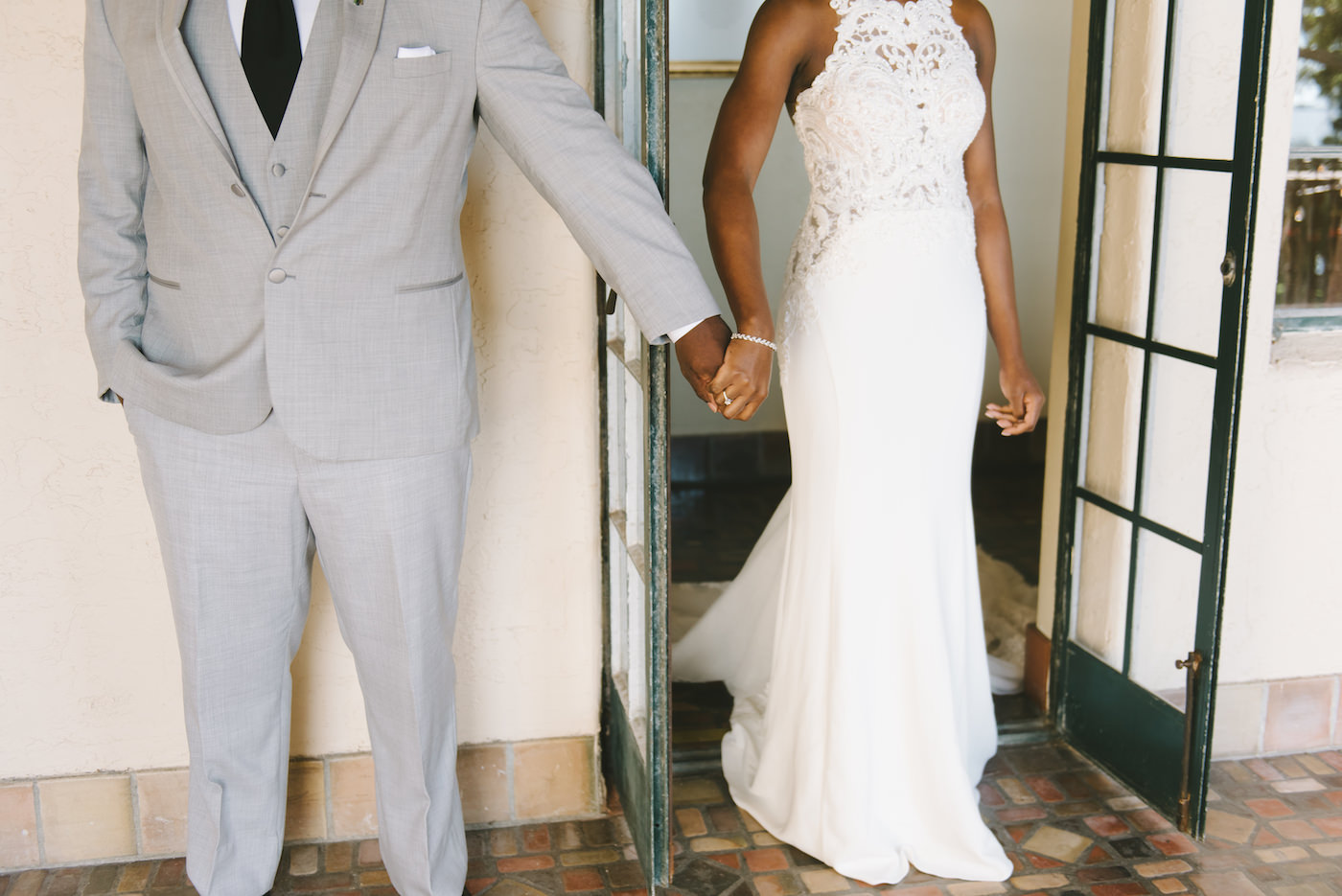 Sarasota Bride and Groom, Holding Hands Behind the Door Before Wedding Ceremony, Bride Wearing Fitted White Lace Dress | Florida Wedding Photographer Kera Photography | First Touch Wedding Portrait