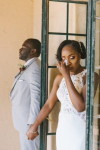 Sarasota Bride and Groom, Holding Hands Behind the Door Before Wedding Ceremony, Bride Wearing Fitted White Lace Dress | Florida Wedding Photographer Kera Photography | First Touch Wedding Portrait