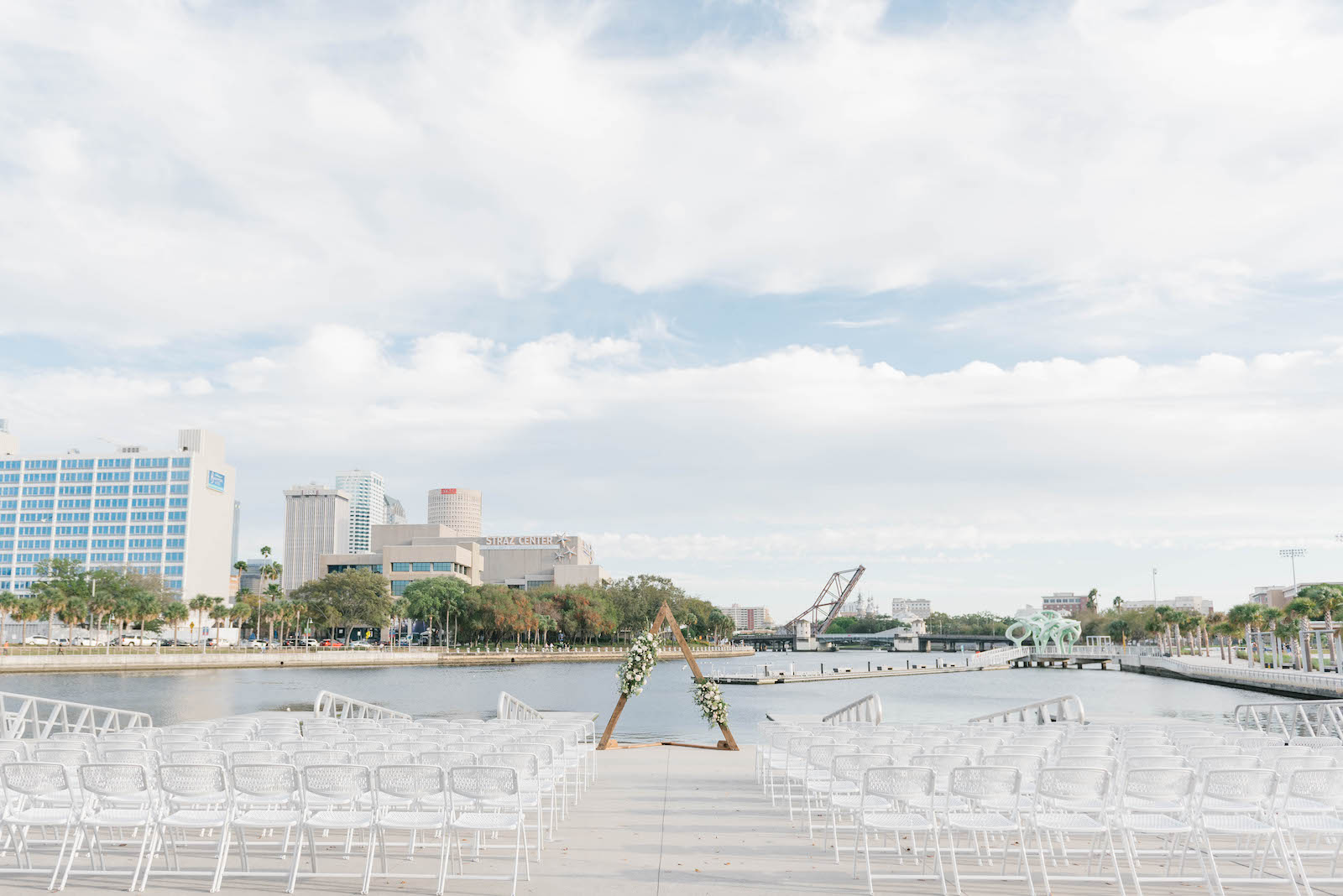 Waterfront Tampa Wedding Ceremony Decor, Triangular Arch with Flowers | Wedding Venue The Tampa River Center | Wedding Planner Parties A'la Carte