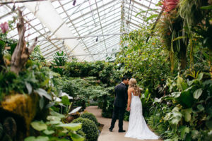 Florida Bride and Groom Intimate Embrace Kiss, Bride Wearing Romantic Hayley Paige Wedding Dress, Groom in Classic black Tux | Marie Selby Botanical Gardens
