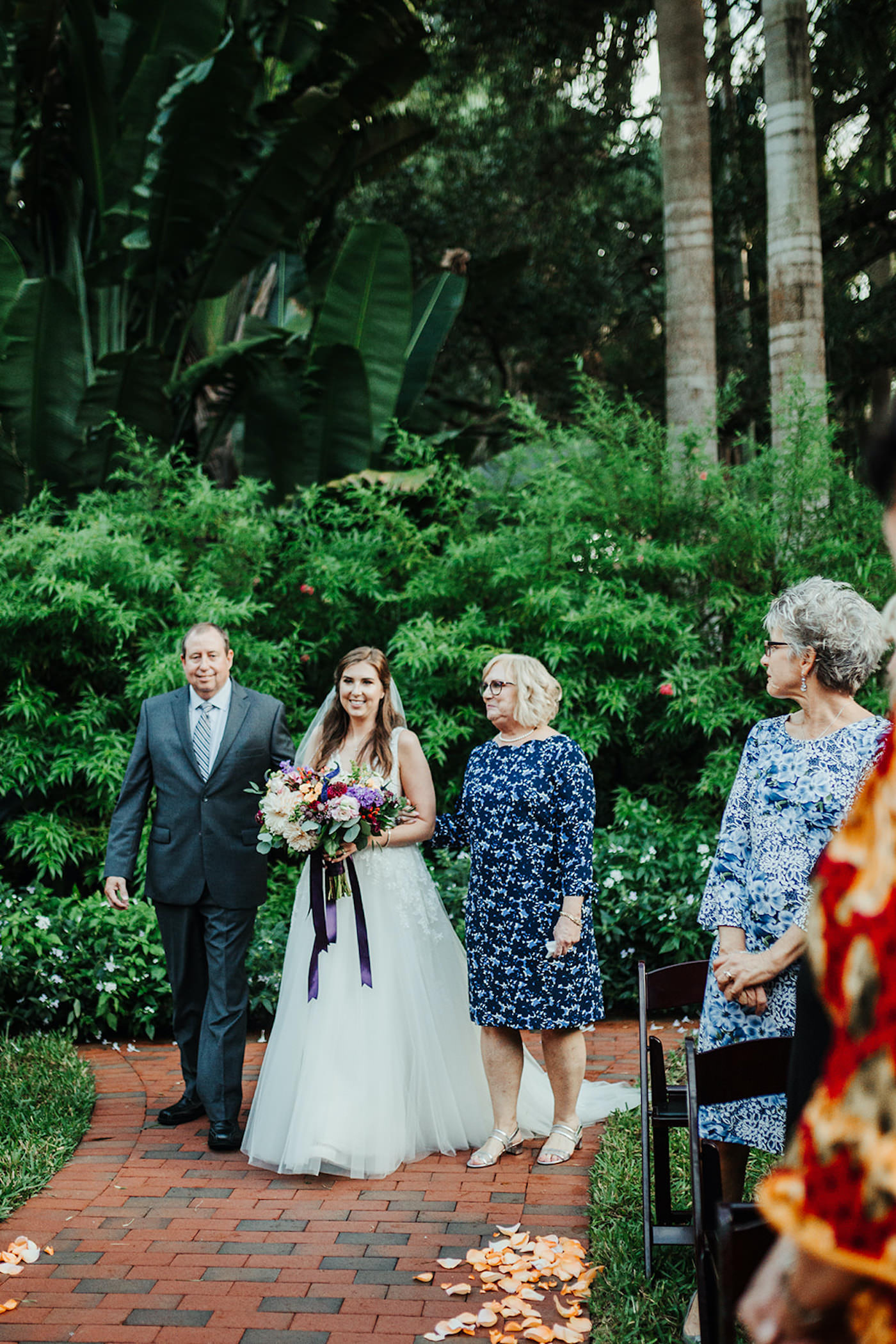 Bride Holding Colorful Floral Bridal Bouquet with Mom and Dad Walking Down the Wedding Ceremony Aisle, Processional Portrait