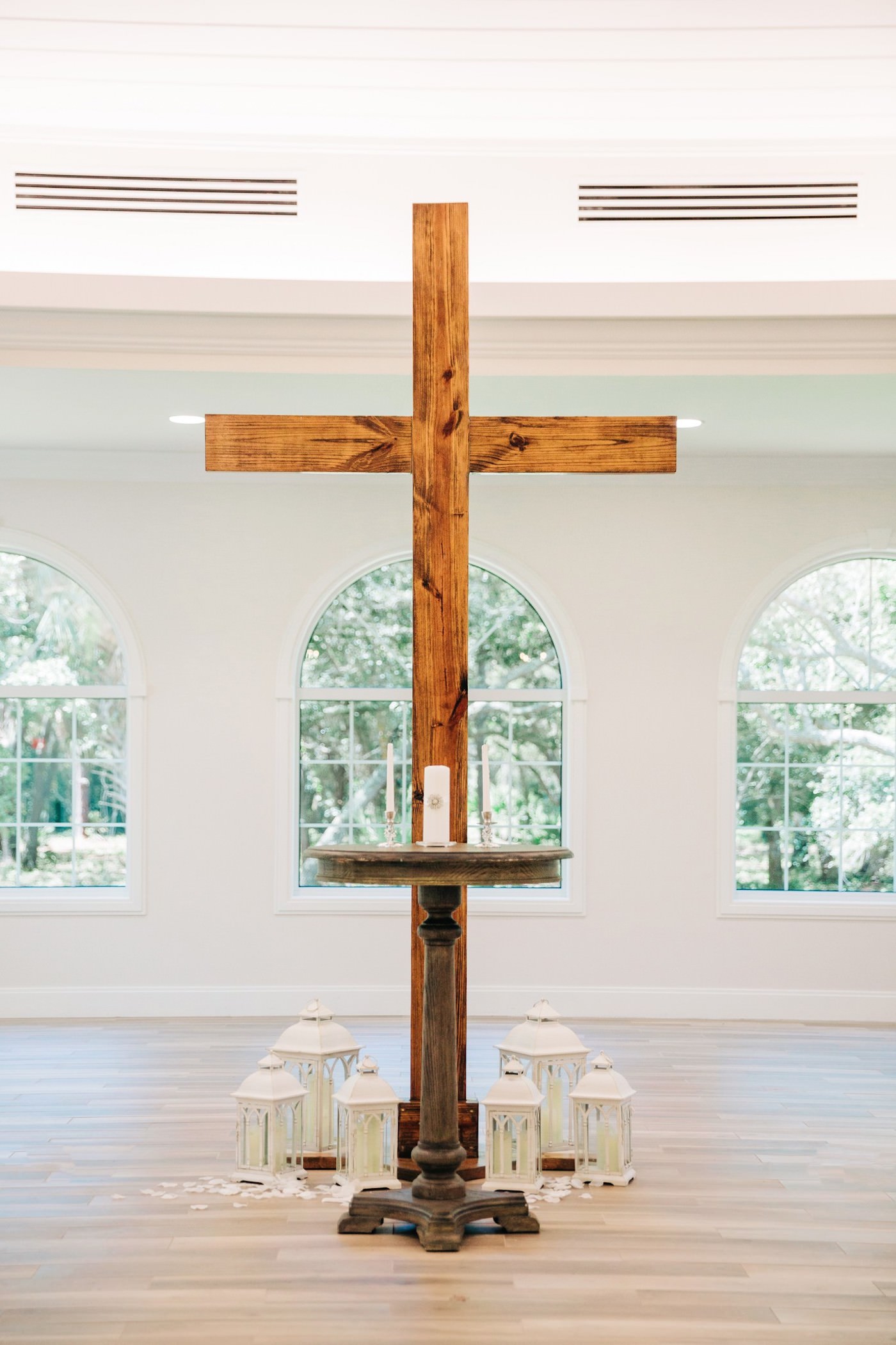 Tampa Bay Wedding Venue Harborside Chapel | Indoor Traditional Church Wedding Ceremony with Cross Backdrop and White Lanterns and Unity Candle