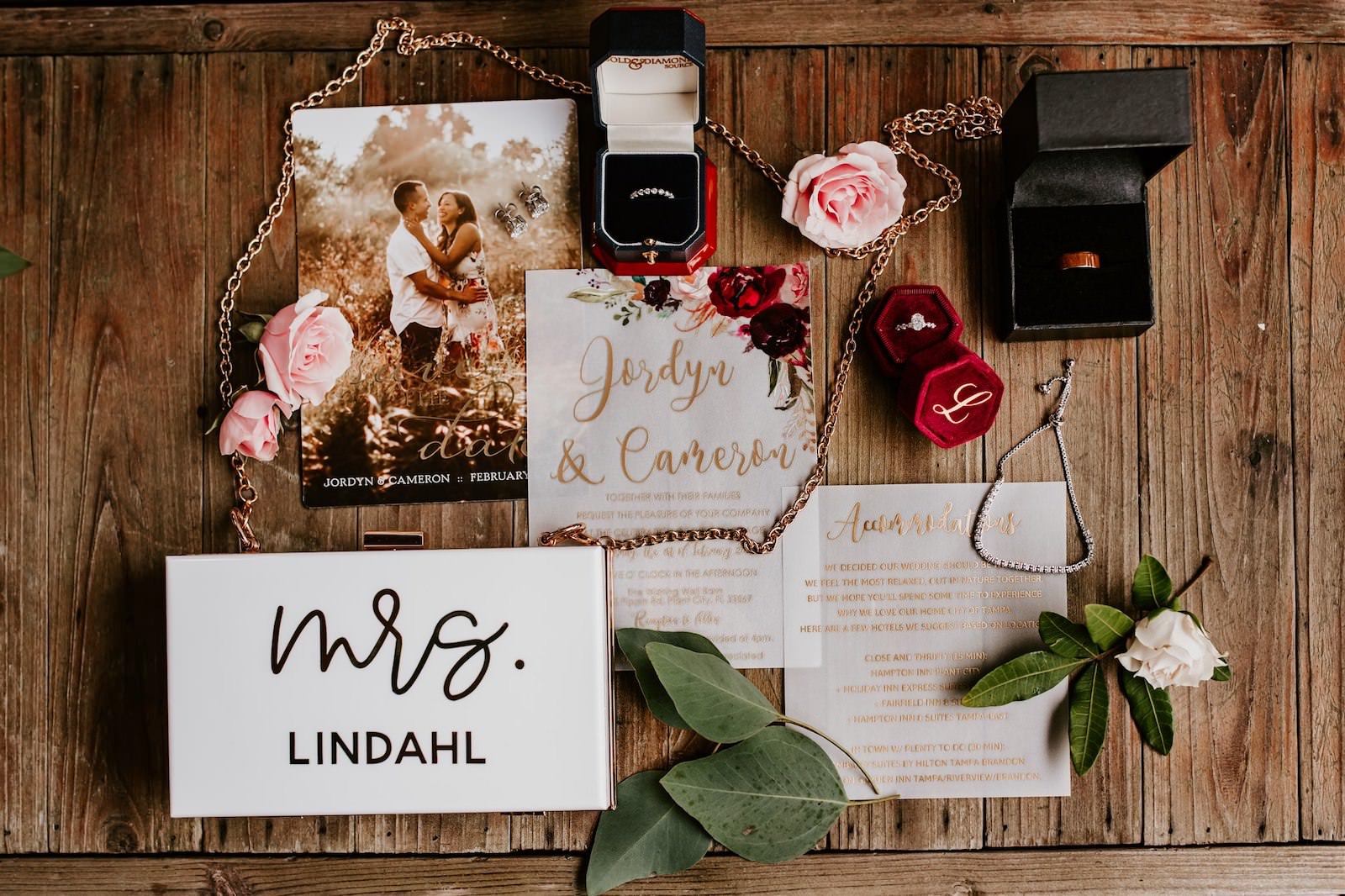 Tampa Wedding Stationery Suite Flat Lay Photo | Maroon Burgundy Deep Red Blush Pink Floral Vellum with Gold Calligraphy and Red Velvet Ring Box | Custom Name Bride Purse Clutch