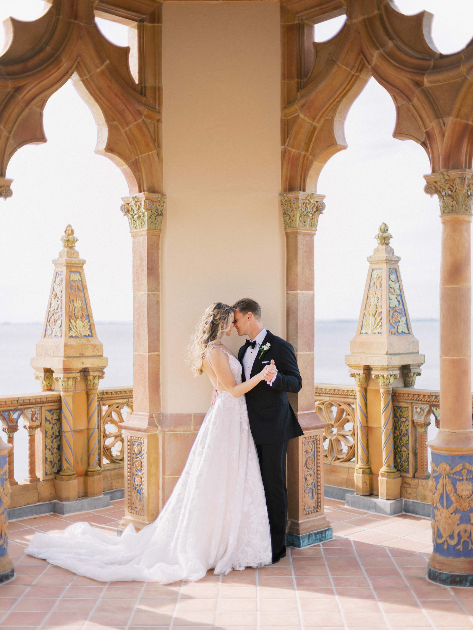 Florida Bride and Groom Intimate Embrace at The Ringling Museum Waterfront Belvedere Tower at the Ca’ d’Zan | Sarasota Wedding Planner NK Weddings