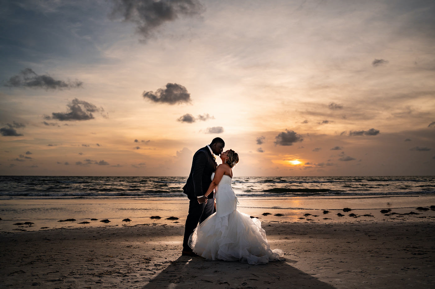 Tampa Bay Bride and Groom Take Sunset Stroll on Clearwater Beach, Bride Wearing Sophisticated Fit and Flare Strapless White Wedding Dress | Florida Wedding Hair and Makeup Artist Michele Renee The Studio