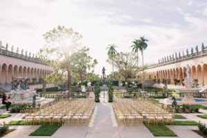 Fairytale Inspired Florida Wedding Ceremony at The Ringling Museum of Art Courtyard in Sarasota, Gold Chiavari Chairs, White Ivory Rose Petals as Aisle Liner, Large Floral Arch with White and Blush Pink Roses | Florida Wedding Planner NK Weddings