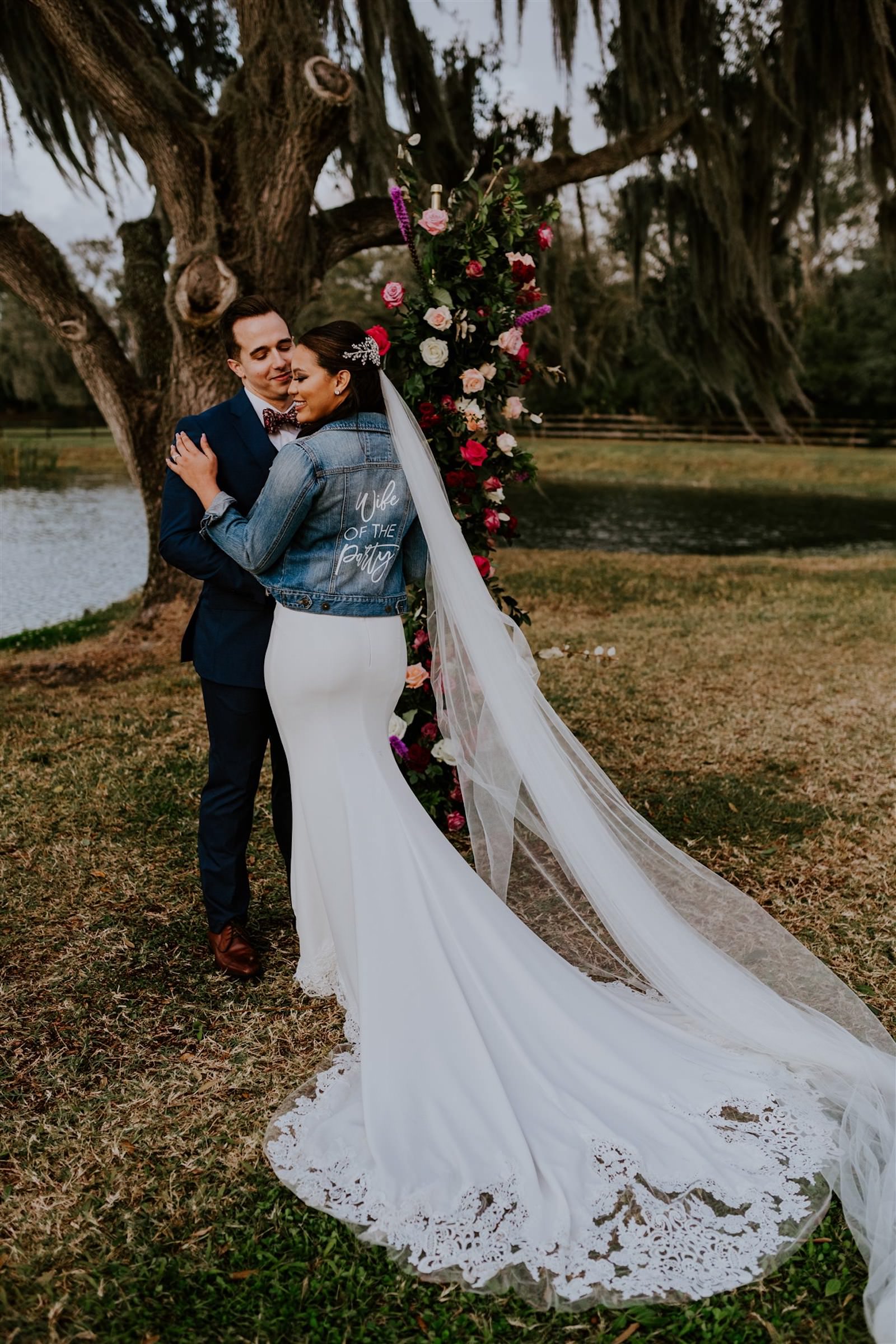 Bride and Groom Outdoor Wedding Portrait with Jean Jacket and Lace Wedding Dress