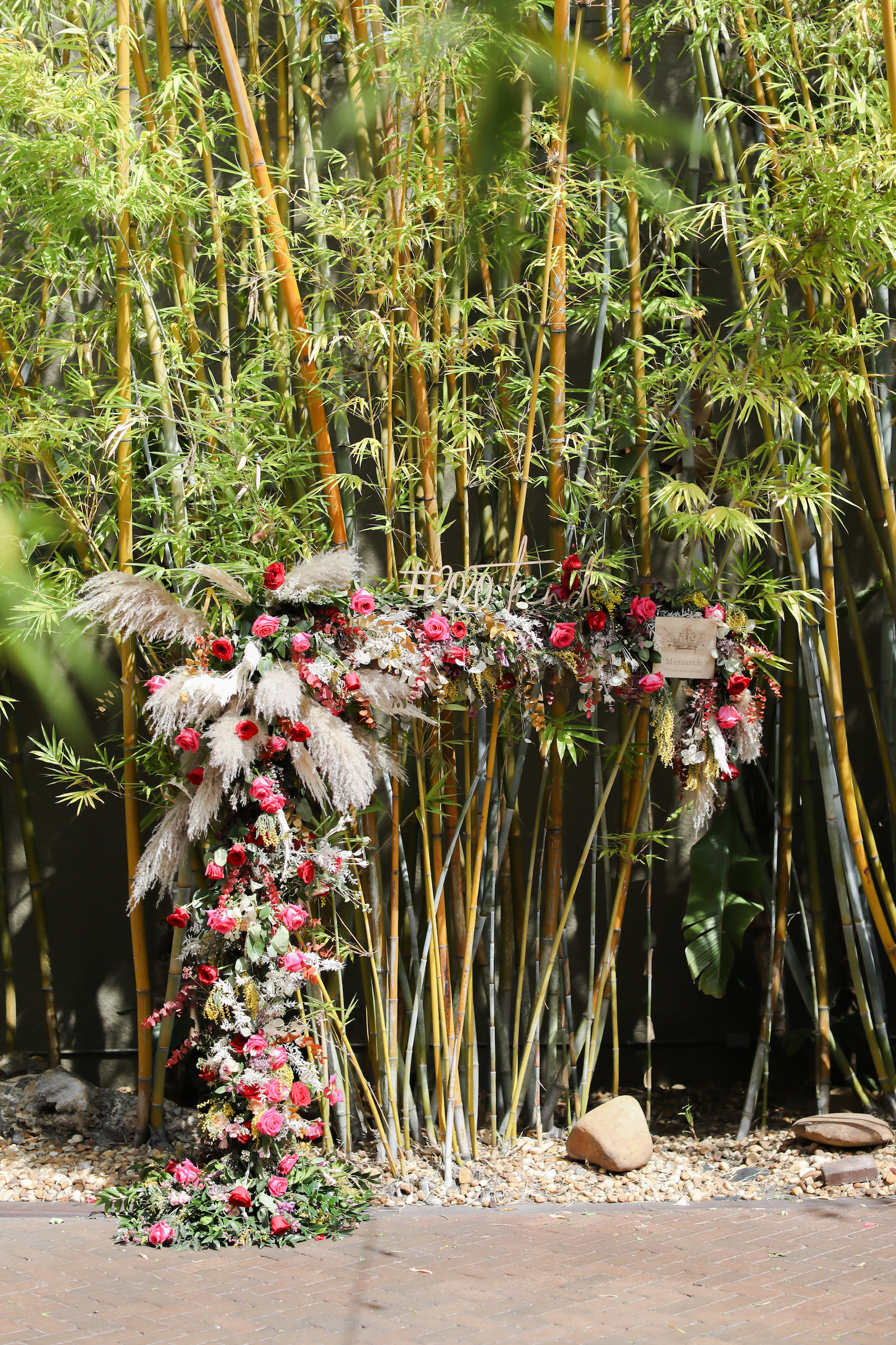 Unique Pampas Grass and Pink Floral Arch in St. Pete Bamboo Courtyard Wedding Venue NOVA 535 | Monarch Events and Design