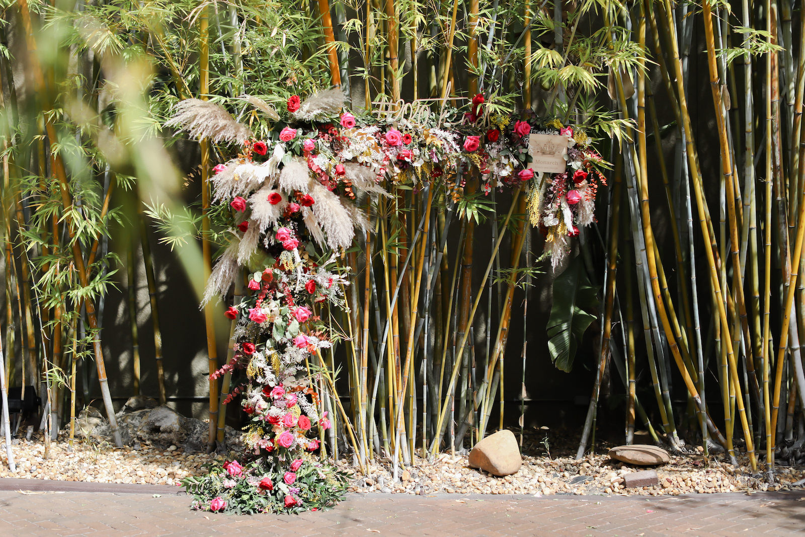 Whimsical Boho Wedding Arch Floral Arrangement with Pampas Grass and Vibrant Roses | Tampa Wedding Florist Monarch Events and Design