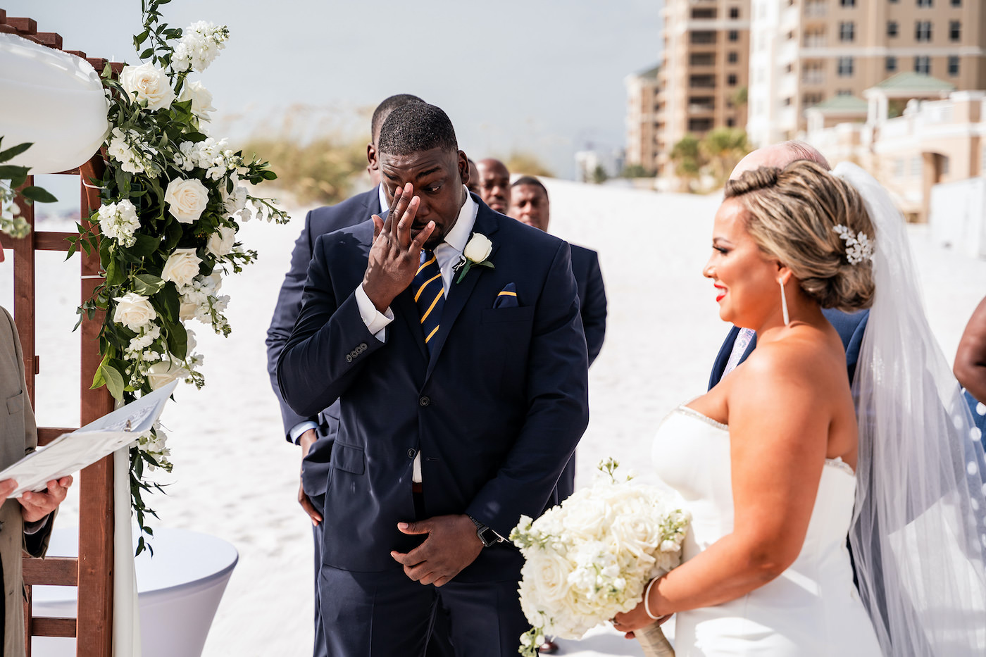 Florida Bride and Groom During Outdoor Beachfront Wedding Ceremony, Tearful Groom, Romantic Tropical Decor with White Roses and Greenery | Tampa Bay Hotel and Wedding Venue Hilton Clearwater Beach
