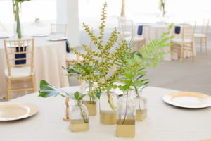 Clearwater Beach Wedding Venue Hilton Clearwater Beach | Modern Tropical Beach Outdoor Wedding Reception Centerpiece with Gold Dipped Bud Vase Bottles of Tropical Palm Frond Leaves