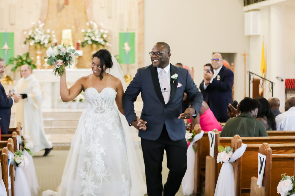 Tampa Bay Bride and Groom Just Married During Exit in Church Ceremony | Florida Wedding Photographer Lifelong Photography Studio | Isabel O’Neil Bridal Collection | Wedding Florist Monarch Events & Design