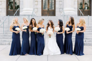 Elegant Bride in Ballgown Hayley Paige Dress Holding Classic White Floral Bouquet, Bridesmaids in Matching Strapless Navy Blue Dresses | Tampa Bay Dress Shop Bella Bridesmaids | Wedding Florist Gabro Event Services | Special Moments Event Planning