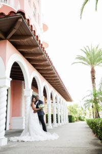 Modern St. Petersburg Bride and Groom Wedding Portraits Outside The Pink Palace Wedding Venue The Don CeSar | Florida Wedding Photographer Lifelong Photography Studio | Blush Pink and Ivory Rose Bridal Bouquet by Monarch Events and Design