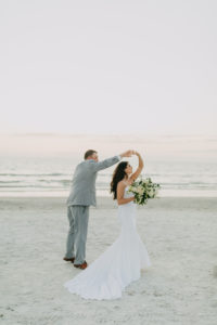 Spaghetti Strap Casablanca Ivory Simple Slip Wedding Dress Bridal Gown | Light Blue Grey Groom Suit | Outdoor Bride and Groom Beach Portrait at Tampa St Pete Florida COVID Destination Elopement Beach Wedding Ceremony | Neutral White Ivory and Greenery Bridal Bouquet | Amber McWhorter Photography