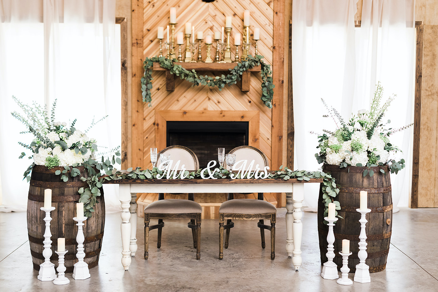 Rustic Chic Wedding Reception and Decor, Antique Farmhouse Sweetheart Table with Mr. and Mrs. Wooden Cut Out, Green Eucalyptus Leaf Garland, White Roses, Ivory Florals and Greenery | Covington Farm | Florida Wedding Planner and Floral Designer John Campbell Weddings | Tampa Bay Caterer Olympia Catering